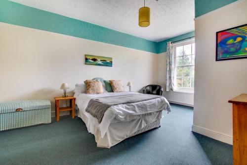 a bedroom with a bed and a window at The Old Rectory in Tattingstone