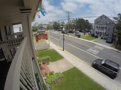 a balcony of a house with a car parked on a street at King Charles Hotel in Ocean City