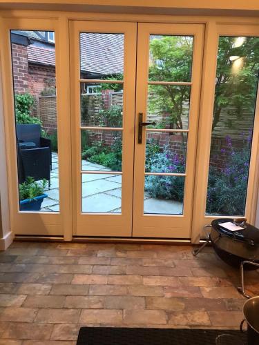 a sliding glass door with a view of a garden at The Lobster Pot in Orford