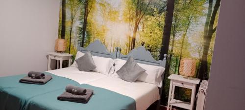 a bedroom with two beds and a painting on the wall at Hostal Urries Restaurante in Urriés