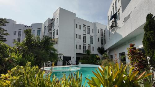 ein Mehrfamilienhaus mit einem Swimmingpool davor in der Unterkunft Adrian's Place at La Bella Tagaytay in Galicias