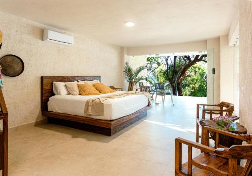 a bedroom with a bed and a sliding glass door at Corrales Bay Resort in Corrales
