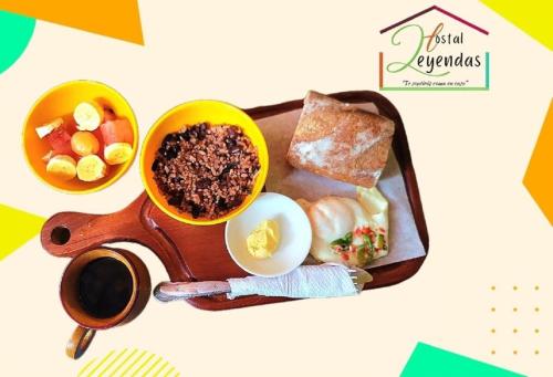 a tray with a plate of food on a table at Hostal Leyendas in León