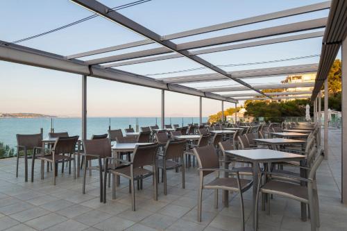 a row of tables and chairs on a patio at Leonardo Royal Hotel Mallorca Palmanova Bay in Palmanova