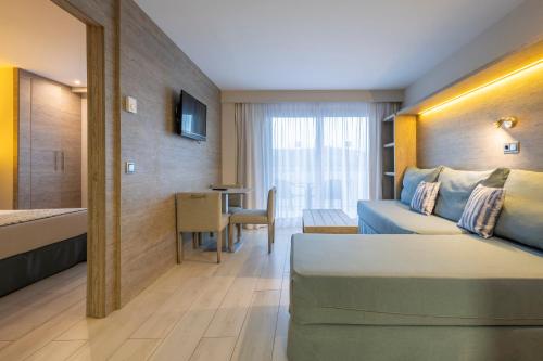 a hotel room with a bed and a table at Leonardo Royal Hotel Mallorca Palmanova Bay in Palmanova