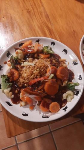 a plate of food with rice and vegetables on a table at The Black Sheep Inn in Chugchilán