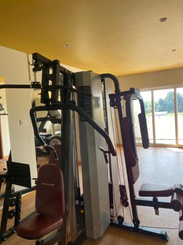a gym with several tread machines in a room at 2BHK Lakeview Apartment in chennai in Siruseri