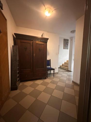 a hallway with a cabinet and a chair in a room at Villatopol in Rząska