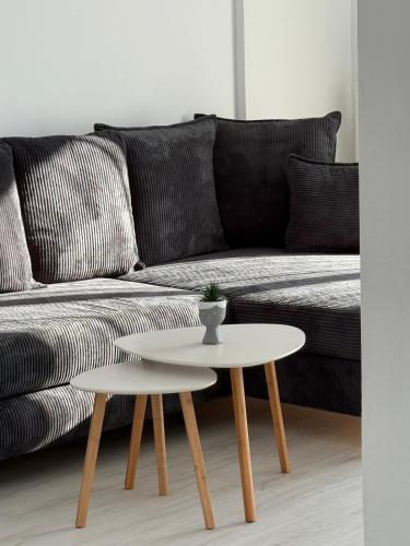 a living room with a couch and a table at Timo Apartments in Bragadiru