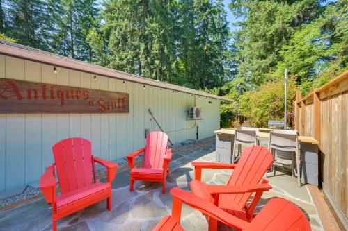 a group of red chairs sitting on a patio at Pet-Friendly Studio with Fire Pit in Olympia! in Olympia