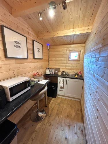 a kitchen with a counter with a microwave on it at The Old Nursery in Stamford