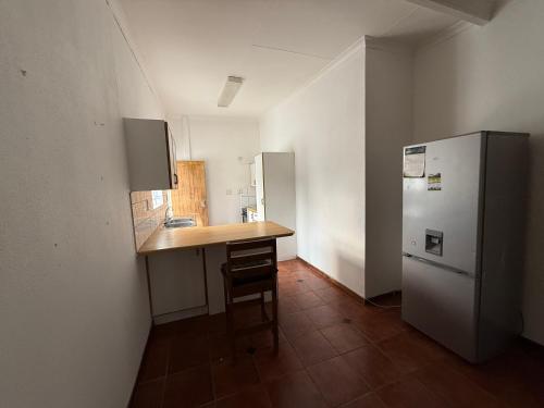 a small kitchen with a counter and a refrigerator at Giribes House Number 1 Kleine Kuppe in Windhoek