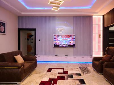 a living room with two couches and a tv at Ay Crib in Kaduna