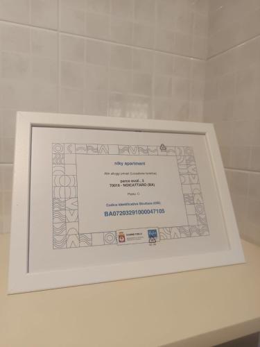 a picture of a certificate in a white frame at Niky apartment in Noicattaro