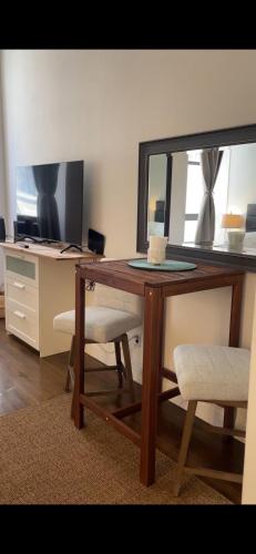 a wooden desk with a mirror and two chairs at Unique Place in midtown NYC in New York