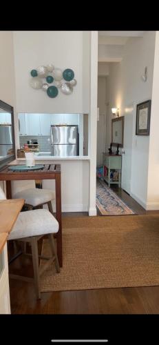 a living room with a table and a kitchen at Unique Place in midtown NYC in New York