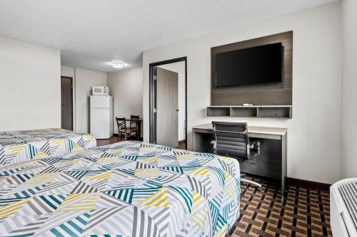 a hotel room with two beds and a flat screen tv at Motel 6 North Sioux City, SD I 29 North in North Sioux City