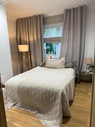 a bedroom with a large bed with a window at WieloDom - kryjówka na wsi in Wielogóra