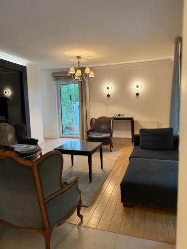 a living room with a couch and a table at WieloDom - kryjówka na wsi in Wielogóra
