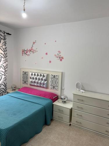 a bedroom with a bed and a dresser at Appartement tangier airport in Hajreien