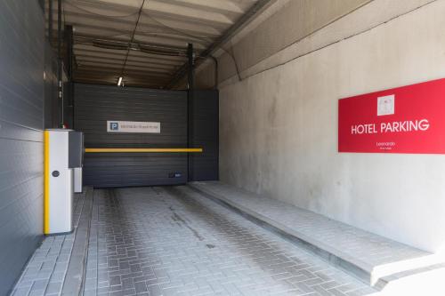 an empty parking garage with a lockpicking sign on the wall at Leonardo Royal Hotel Amsterdam in Amsterdam