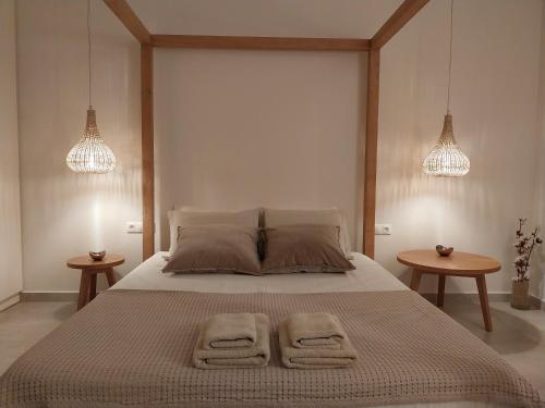 a bedroom with a large bed with two towels on it at Villa Evriali in Plakias