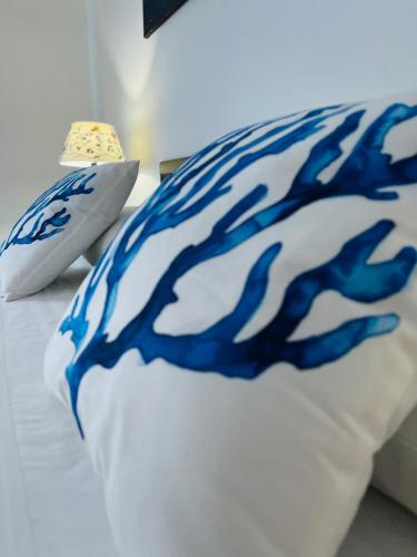 a blue and white pillow on a bed at La Gorgonia in Trapani