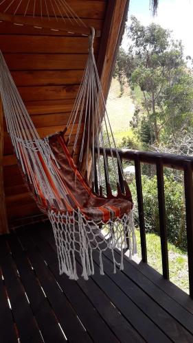 a hammock on a porch of a house at The Black Sheep Inn in Chugchilán