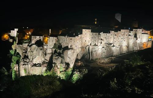 a castle on top of a cliff at night at WelcHome Vitorchiano in Vitorchiano