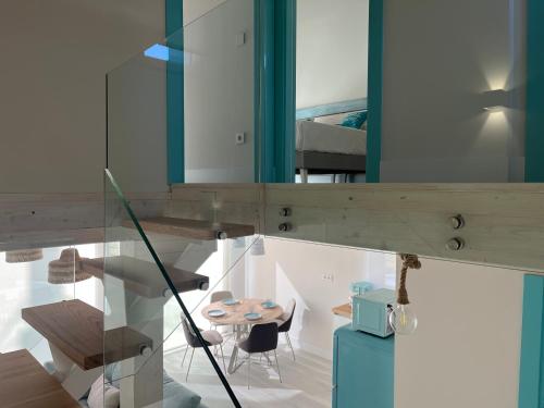 a room with a table and a mirror at Apartamentos Catamarán Azul in Suances