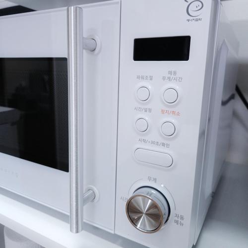 a microwave oven sitting on top of a counter at 포근한 하루 투룸 in Icheon