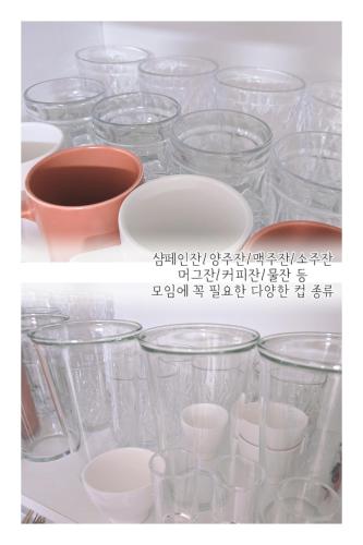 a bunch of glass cups and bowls on a shelf at 포근한 하루 투룸 in Icheon