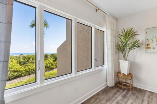 a room with windows with a view of the ocean at 1401 Windsong in Amelia Island