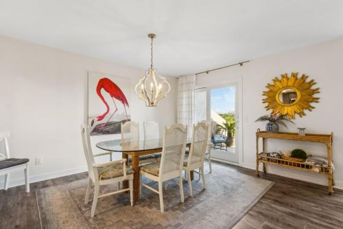 a dining room with a table and chairs and a mirror at 1401 Windsong in Amelia Island