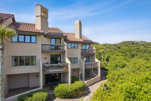 an exterior view of a large house with balconies at 1401 Windsong in Amelia Island