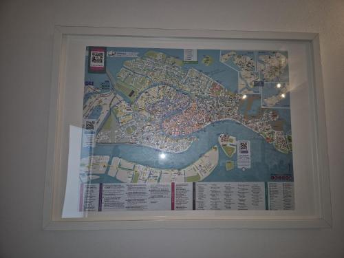a map hanging on a wall in a room at QUEEN HOME Emanuelle in Venice
