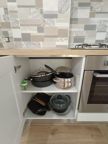 a kitchen drawer with pots and pans on it at Solleone - Appartamento 2B in Paestum