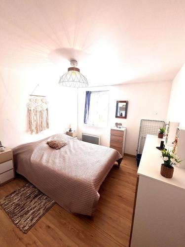 a bedroom with a large bed and a window at Grande maison avec tranquillité garantie in Lessay