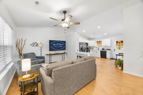 a living room with a couch and a ceiling fan at MiniGolf, HotTub, FirePit, PetFriendly, Sleeps 8 in Greenville