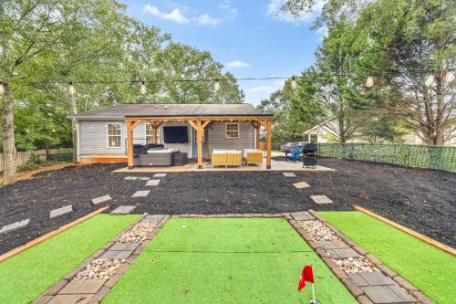 a backyard with a gazebo and green grass at MiniGolf, HotTub, FirePit, PetFriendly, Sleeps 8 in Greenville