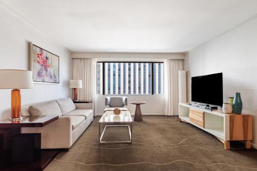 a living room with a couch and a tv at Grand Hyatt Denver in Denver