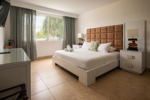a bedroom with a large white bed and a window at Beach Apartment At Nikki Residences 2 Bedroom in El Chirú