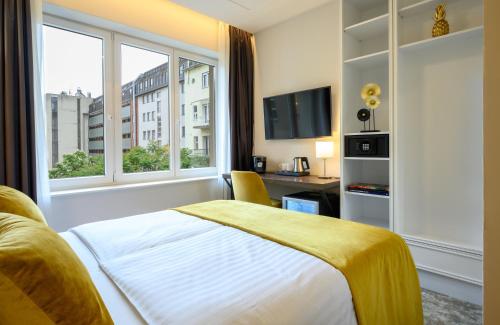 a hotel room with a bed and a window at Leonardo Boutique Hotel Budapest M-Square in Budapest