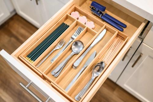 a wooden tray with silver utensils in a drawer at Central Location Master Bedroom w Shared Bathroom in Irvine