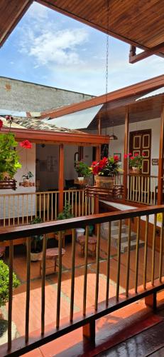 a porch of a house with flowers on it at Casa Patrimonial Abejorral - CASA GASAMA in Abejorral