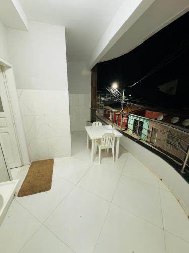 a large white room with a table and chairs at Serra Flat in Tianguá