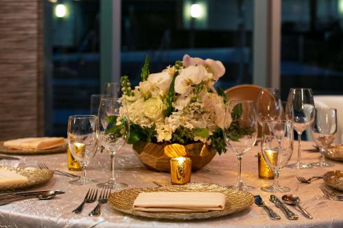 a table with a vase of flowers and wine glasses at The Royal Sonesta Chicago River North in Chicago