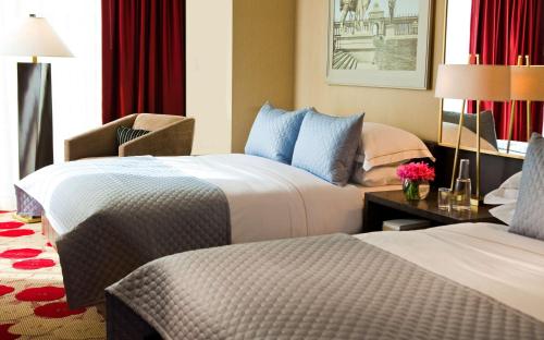 a hotel room with two beds and a desk at The Royal Sonesta Chicago River North in Chicago