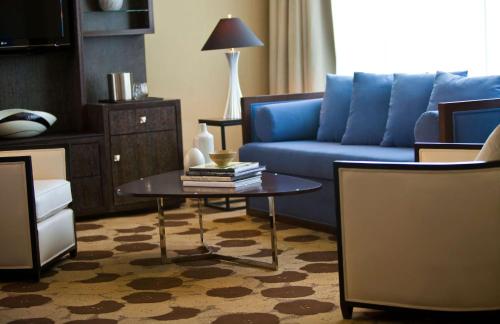 a living room with a blue couch and a table at The Royal Sonesta Chicago River North in Chicago
