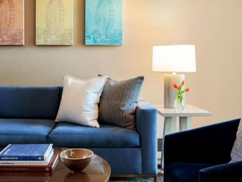 a living room with a blue couch and a table at The Royal Sonesta Chicago River North in Chicago